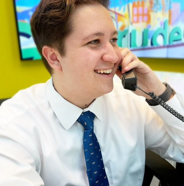 Man on phone wearing neck tie.