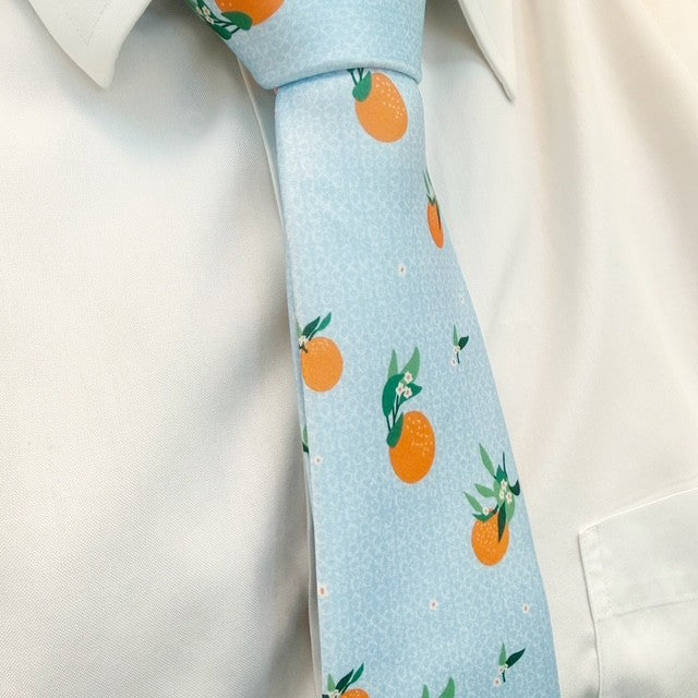 Light blue tie with oranges