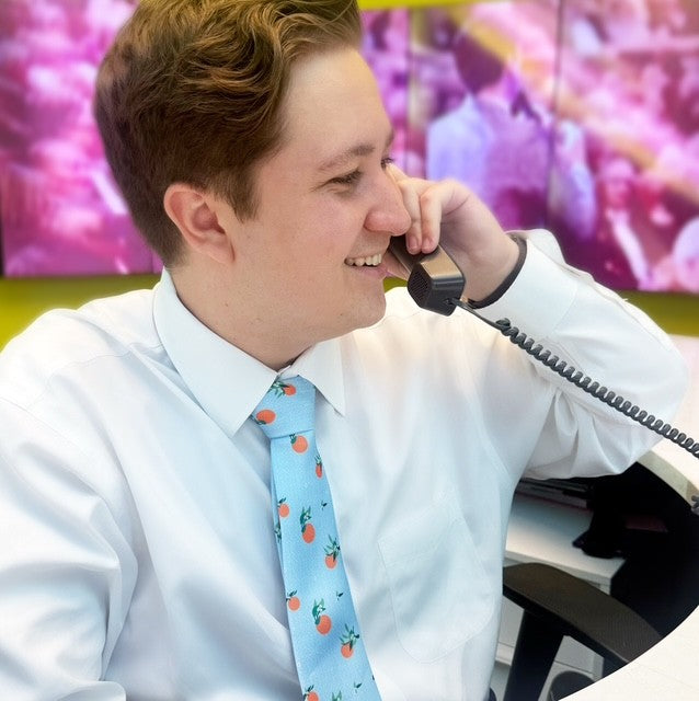 Light blue neck tie with man on phone.