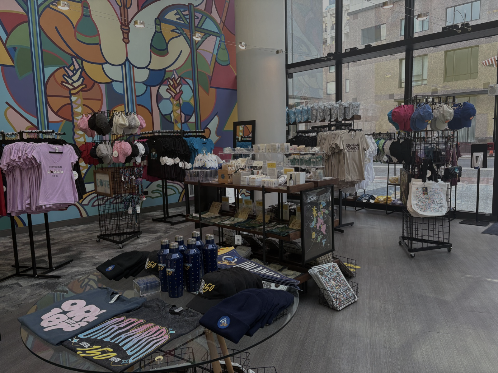 Store interior with merchandise on display against a colorful mural.
