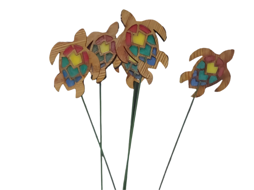 Wooden turtle decorations with colorful patterns on a black background