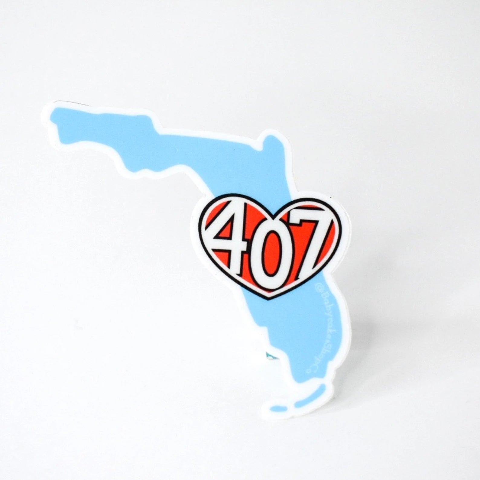 Sticker of the map of Florida with a heart-shaped '407' in the center on a white backgroundi
