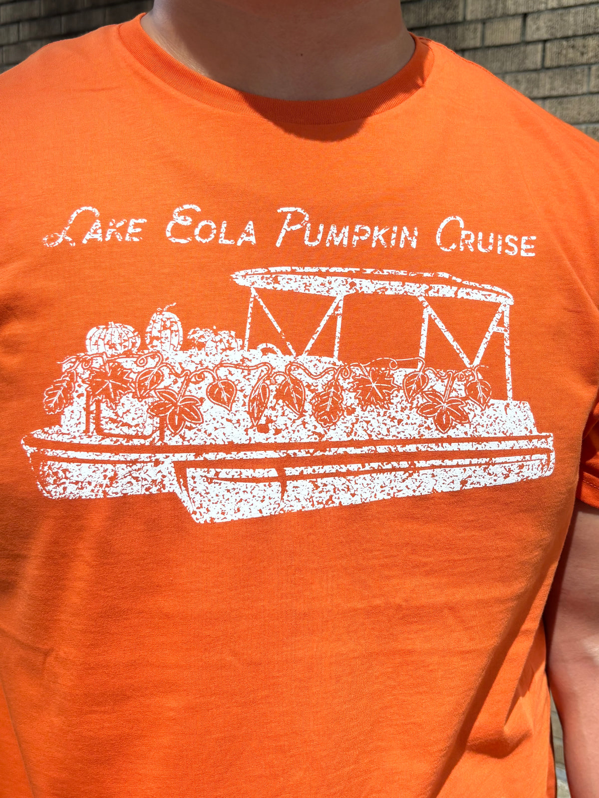 Pumpkin boat on orange shirt.