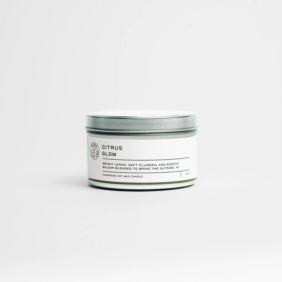 Candle tin labeled 'Citrus Glow' on a white background